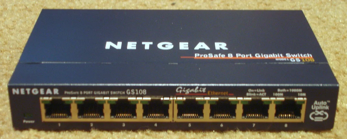 Eight Ethernet ports on the front of an older NETGEAR GS108 desktop network switch